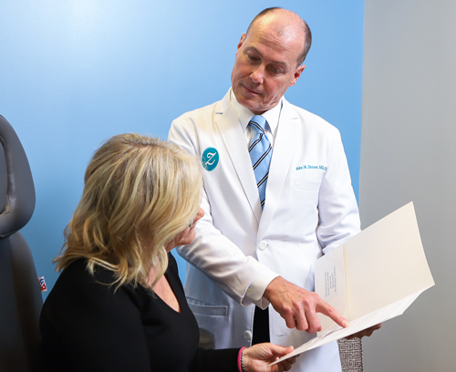 Dr. Zinsser talking to a patient in Richmond, VA Zinsser Plastic Surgery